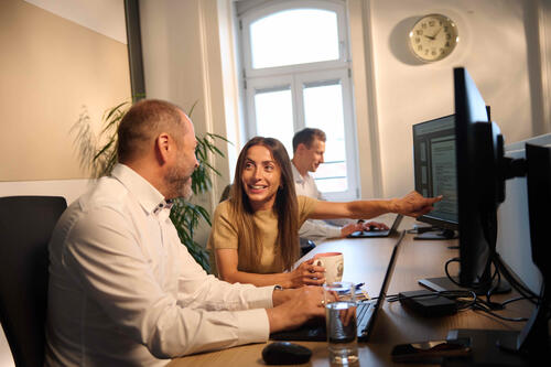 ÖBV Versicherungsmitarbeiter:innen im Gespräch vor einem Computer.