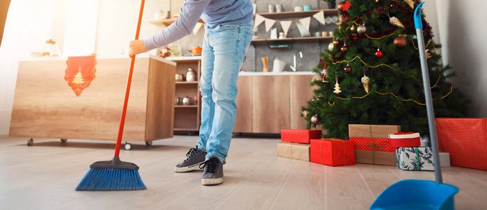 Mid adult man sweeping floor with a broom